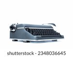 Small photo of old-style vintage mechanical typewriter made of metal, with black keys and a distinct lever for the carriage return. Set on a white backdrop, viewed at three-quarters from its level