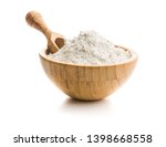 Whole grain wheat flour in bowl isolated on white background.