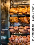 Small photo of Showcase of selling an oven with grilled chicken grill in a small street shop in a busy place at the exit of the Moscow metro. Grilled chickens are invariably in great demand.