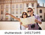Happy tourists sightseeing city with map