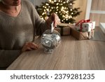 Caucasian woman saving money for Christmas presents