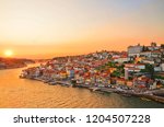 Magnificent sunset over the Porto city center and the Douro river, Portugal. Dom Luis I Bridge is a popular tourist spot as it offers such a beautiful view over the area. 