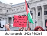 Small photo of Buenos Aires, Argentina, Feb 16, 2024: demonstration in solidarity with Palestine and against Israel attack and genocide. Palestinian flag and sign with the text Stop the genocide, cease fire now!!!