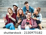 Small photo of Multicultural urban friends having fun on mobile phone devices at grungy place - Young happy guys and girls sharing time together watching trendy funny video on smartphone - Bright contrast filter