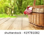 red napkin picnic basket and table place 
