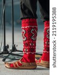 Small photo of Detail of the national ethnic Macedonian costume. Macedonian traditional folklore musician perform at festival in Northern Macedonia. Mans legs in macedonian socks with folklore design close-up.