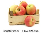 Small photo of fresh Maribelle apples in a wooden crate on a white background