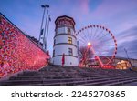 Small photo of DUSSELDORF; GERMANY - DECEMBER 29; 2022: Wheel of vision and historic castle tower during sunset on December 29; 2022 in Dusseldorf; Germany