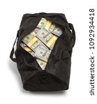 Small photo of Black Duffel Bag Full of Money Isolated on a White Background.