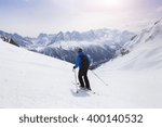 Skier Skiing On Red Slope In...