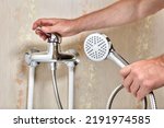 Plumber connected showerhead with flexible hose to single lever faucet in bathroom.
