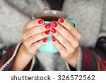 Female hands holding a mug of hot tea