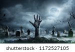 Zombie Hand Rising Out Of A Graveyard In Spooky Night
