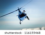 Front view of helicopter in flight. Fly over the snow mountain.