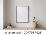 Small photo of Elegant Mediterranean home interior. Summer home still life photo. Vase with green olive tree branches, wooden table. Blank picture frame mockup hanging on wall. Cup of coffee, tea and old books.