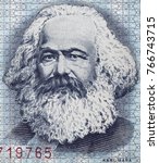 Small photo of Karl Marx portrait on East German 100 mark (1975) banknote closeup macro, famous philosopher, economist, political theorist, sociologist and revolutionary socialist.