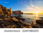 Stunning view of Vernazza village in Cinque Terre National Park, beautiful cityscape with colorful houses, sea and a harbor at sunset, Liguria region of Italy. Outdoor travel background