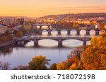 View to the historical bridges, Prague old town and Vltava river from popular view point in the Letna park (Letenske sady), beautiful autumn landscape in soft yellow morning light, Czech Republic