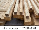 Large wooden beams for construction. Building material. Sawed beam