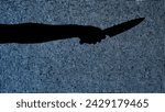 Small photo of Silhouette against digital television screen. Thriller scene woman hand holding knife and stabbing it against digital screen with noise.
