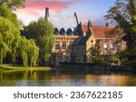 Small photo of Vintage building over lake of love in Minnewater park Bruges Belgium near Beguinage monastery Beguines. Picturesque landscape with green trees sunset time. Famous travel destination Europe