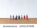 Miniature people : Businessman sitting on old book  with copy space on white background