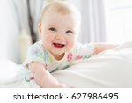 A Baby Girl In White Bedding At ...