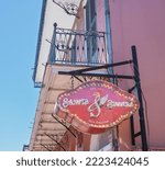 Small photo of NEW ORLEANS, LA, USA - APRIL 3, 2022: Sign on Channing Tatum's Saints and Sinners bar on Bourbon Street in the French Quarter