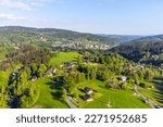 Zdar - part of Tanvald town in the middle of green hills of Jizera mountains on sunny summer day. Czech Republic. Aerial view from drone.