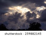 Small photo of A Dramatic Sunset with Approaching Climactic Summertime Thunderstorm with Silhouetted Trees