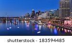 Australia sydney Darling Harbour sunset panorama vividly illuminated city landmarks with reflection in harbour water