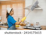Small photo of Asian maid in workwear and gloves cleans home dusts ventilation in kitchen. Hygiene emphasized housework equipment in use. Clean air brush maid service modern hygiene. maid housekeeping concept.