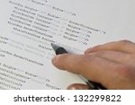 Small photo of A programmer / man pointing with his pen at software computer code. Software / application program code. XML parser.
