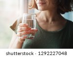 healthy beautiful young woman holding glass of water 