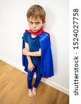 Small photo of hurt sad superhero child feeling denigrated, frustrated, scared, disappointed by parenthood and education through his body language