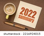 Small photo of 2022 year summary text on a napkin with a cup of coffee, end of year business concept