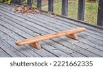 Small photo of Persian shena push up board on a backyard wooden deck