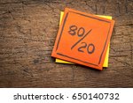 Small photo of Pareto principle or eighty-twenty rule represented on a sticky note against rustic wood - a reminder or advice