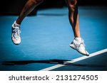 Small photo of MELBOURNE, AUSTRALIA - JANUARY 24, 2022: Closeup of footwork and legs of an active tennis player on a hot summer's day in Melbourne, Australia