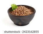 Small photo of Buckwheat in a pot, isolated on white background