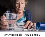 Small photo of Oldster taking daily medication dose at home, Andalusia, Spain