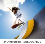 Small photo of Skateboarder doing a jumping trick. Freestyle extreme sports concept