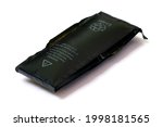 Swollen lithium ion polymer battery inside a mobile phone on white background isolated