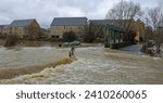 Small photo of LITTLE PAXTON, CAMBRIDGESHIRE, ENGLAND - JANUARY 05, 2024: Flooding river Ouse causing bridge and road to be shut off.