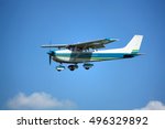 Light general aviation cessna aircraft on final with cloud sky landing configuration