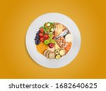 Small photo of Healthy food pie chart on white plate, healthy balanced eating concept. Food sources of carbohydrates, proteins and fats in proper proportions for diet and nutrition planning. Top view