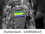 Small photo of Flag of Gabon on soldiers arm. Gabonese Republic flag on military uniform. Army, troops, military, Africa (collage).