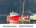 Small photo of Lobster boats and skiffs on a misty calm morning in Round Pond Maine