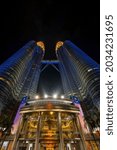 Small photo of Kuala Lumpur, MALAYSIA - 31 August 2021: Petronas Twin Towers (known as KLCC) displaying the colors of the Malaysian flag, which are red, yellow and blue during the 64th National Day celebration.
