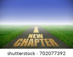 New chapter printed in gold on road with green grass on each side